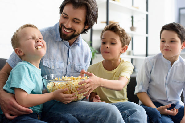 Family eating a bowl of popcorn.