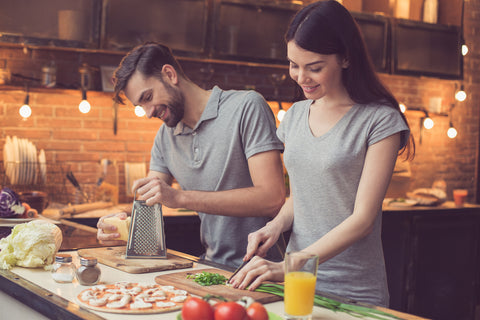 Couple cooks a meal at their vacation home.
